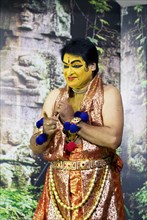 Kathakali performer or mime, 60 years old, on stage at the Kochi Kathakali Centre, Kochi, Kerala,
