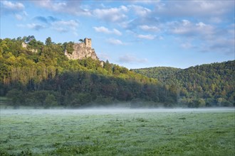 Neideck castle ruins in the morning mist in the Wiesenttal valley, landmark of Franconian