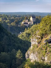 View of the Puettlach valley with rocks, forests and Pottenstein Castle, Franconian Switzerland,