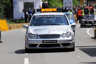 The white Mercedes-AMG safety vehicle on a race track surrounded by spectators, SOLITUDE REVIVAL