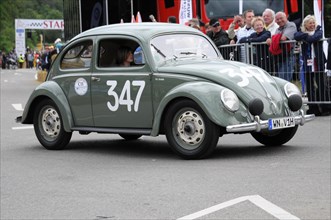 A green Volkswagen Beetle classic car with racing number on the road, SOLITUDE REVIVAL 2011,
