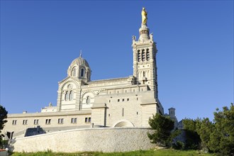 Church of Notre-Dame de la Garde, Marseille, Large historic church under a cloudless blue sky,