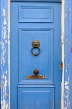 Marseille, Detailed view of an old blue door with door knocker and peeling paint, Marseille,
