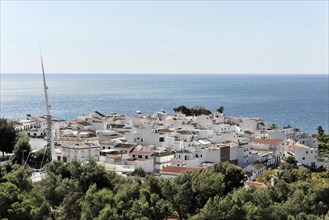 Solabrena, Sunny view of a Spanish coastal town with whitewashed houses and sea view, Andalusia,