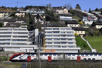 Multi-family houses on a slope SBB passenger train, Switzerland, Europe