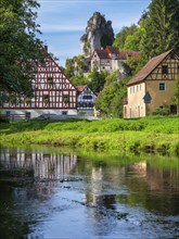 Zechenstein rock formation and half-timbered houses on the Puettlach river, rock castle and