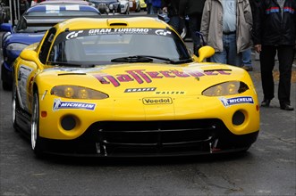 A yellow racing car with advertising stickers and the Michelin logo, SOLITUDE REVIVAL 2011,