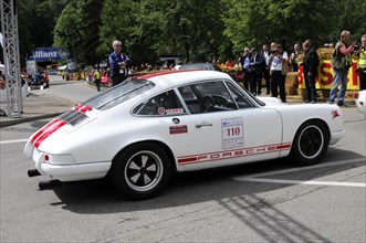 Side view of a white Porsche racing car with racing stripes at a motorsport event, SOLITUDE REVIVAL