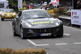 A Ferrari as a pace car on a secured race track surrounded by spectators, SOLITUDE REVIVAL 2011,