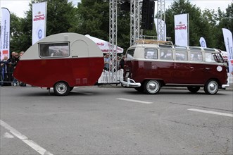 Side view of a VW bus with caravan in front of a crowd of spectators, SOLITUDE REVIVAL 2011,