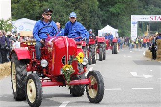 Porsche diesel tractors, drivers in red vintage tractors take part in a rally, SOLITUDE REVIVAL