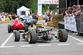 Colourful formula car at the start of a race with spectators in the background, SOLITUDE REVIVAL