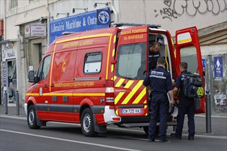 Marseille, rescue workers standing next to a fire engine in action, Marseille, Departement Bouches