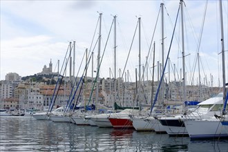 Marseille harbour, sailboats anchored in the marina against the backdrop of an old city, Marseille,