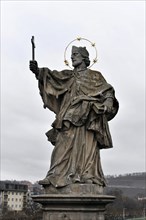 The bridge saint Johannes von Nepomuk, old Main bridge, Wuerzburg, statue of a saint with nimbus