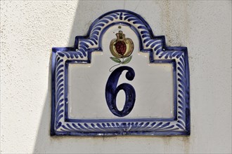 Solabrena, Blue and white ceramic house number with crown and ornaments on a wall, Andalusia,