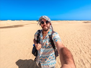 Selfie of a tourist on vacation in the dunes of Maspalomas, Gran Canaria, Canary Islands