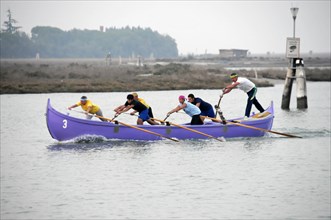 Burano, Burano Island, A group of rowers in a competition on calm water, Burano, Venice, Veneto,