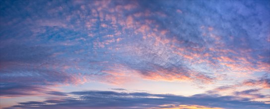 Blue sky with pink clouds in the evening light, panorama, wallpaper, sky replacement