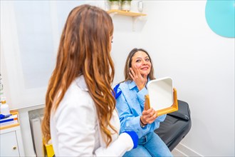 Satisfied woman talking to doctor after beauty treatment applying hyaluronic acid injection on lips