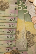 Close-up of reverse side of green, yellow and pink Canadian Bank of Canada twenty dollar bills with