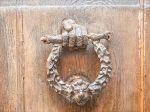 Hand holding door knocker, Alghero, Sardinia, Italy, Europe