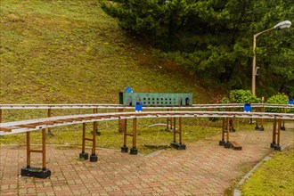 Miniature outdoor train station surrounded by trees on a cloudy day, in South Korea
