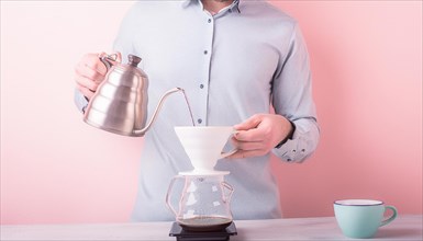 Focused individual manually brewing pour-over coffee with a pink background, horizontal, AI