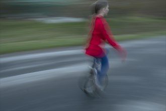 Girl, 10 years old, riding a unicycle, motion blur, Mecklenburg-Vorpommern, Germany, Europe