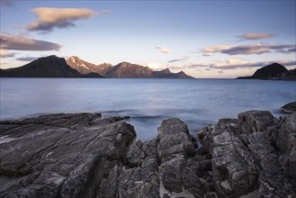 Seascape on the beach at Haukland. View of the mountains of Myrland on Flakstadoya. Rocks in the