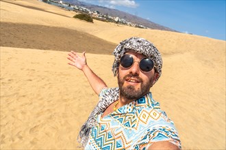 Selfie of a tourist on vacation smiling in the dunes of Maspalomas, Gran Canaria, Canary Islands