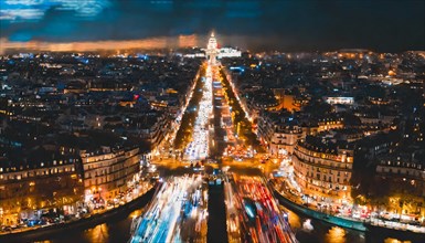 Panoramic night view of Paris with city lights and traffic creating a vibrant scene, rush hour