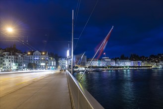 Cityscape and a Bridge with Swiss Flag and Lake Lucerne in Long Exposure at Night in Switzerland