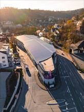 Drone image of a modern building on a street corner in the evening light, Calw, Black Forest,