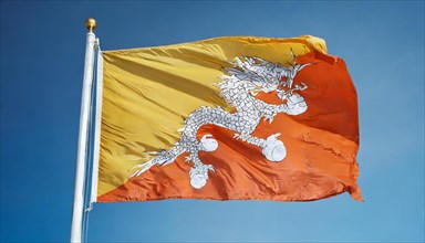 Flag, the national flag of Bhutan flutters in the wind