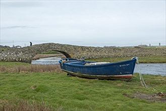 Stone bridge, fishing boat, man, Aberffraw, Isle of Anglesey, Wales, Great Britain
