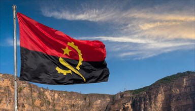 Flag, the national flag of Angola flutters in the wind