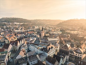 Sunset over a town with church towers and densely built-up houses, sunrise, Nagold, Black Forest,