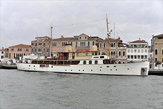 FAIR LADY, Traditional yacht in the water in front of historic Italian buildings, Venice, Veneto,