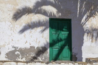 Typical house entrance on Fuerteventura with the shade of a palm tree, Fuerteventura, Canary