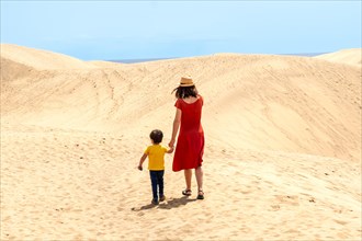 Mother and son tourists exploring the dunes of Maspalomas, Gran Canaria, Canary Islands
