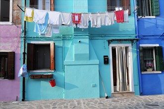 Colourful houses, Burano, Burano Island, Traditional everyday life with laundry drying on a