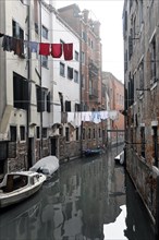 Rainy atmosphere on a Venetian canal with washing lines, Venice, Veneto, Italy, Europe