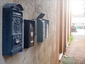 Letterboxes on a house wall, Olbia, Sardinia, Italy, Europe