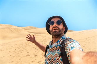 Selfie of a tourist enjoying in the dunes of Maspalomas, Gran Canaria, Canary Islands