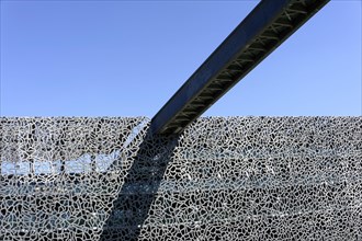 Modern metal structure of a building with an interesting pattern against a clear sky, Marseille,