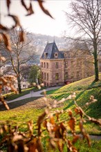 Old villa surrounded by trees with autumn leaves, atmospheric lighting, Calw, Black Forest,