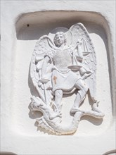 Stone sculpture, St George as dragon slayer, relief on the facade of the Stella Maris church, Porto