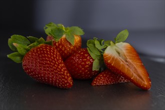 Strawberries (Fragaria) on a slate plate