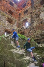 Two boys climbing in the tower in Hammershus which was Scandinavia's largest medieval fortification